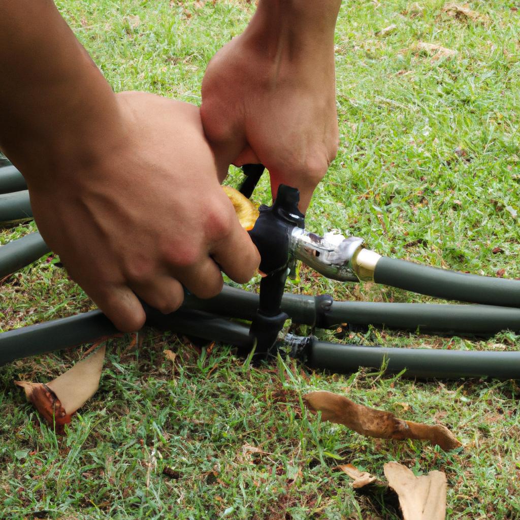 Person connecting water hose outdoors
